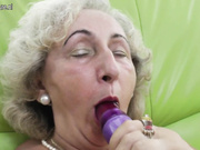 Old grandma playing with a purple dildo