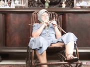 Hairy Granny Is Knitting Some Woolen Socks While the Hard